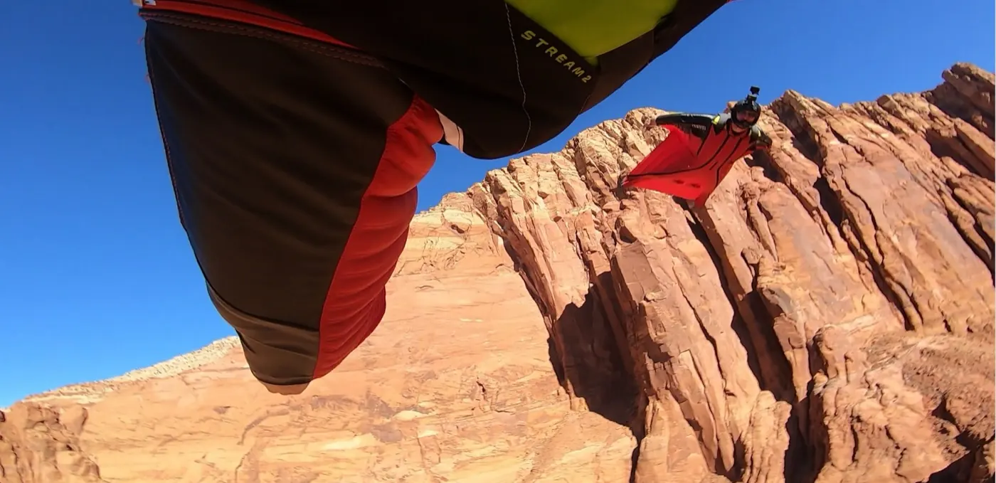 Wingsuit flight past desert rock