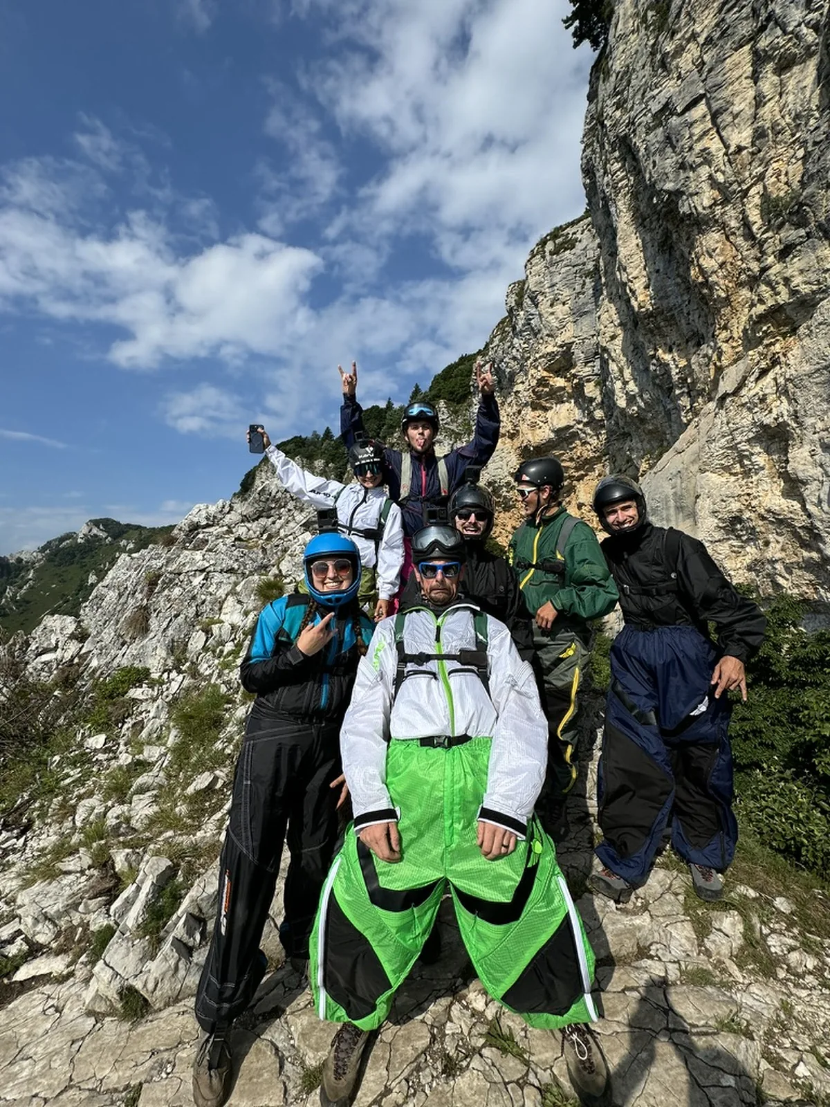 Students in wingsuits celebrating on the trail